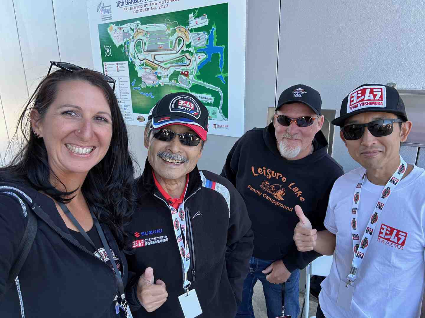 a group of bikers talking and smiling together at an outdoor event - motorcycle accident help