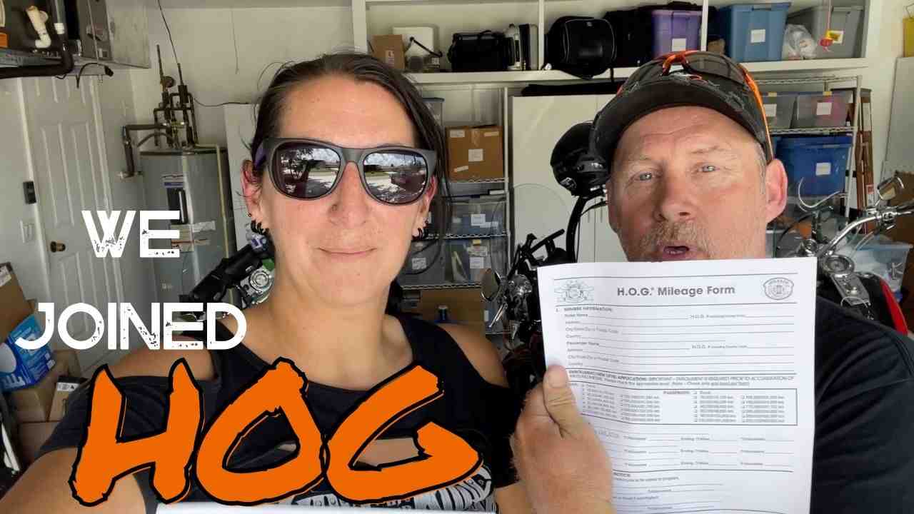 hog members holding a mileage form  - Harley Davidson rally