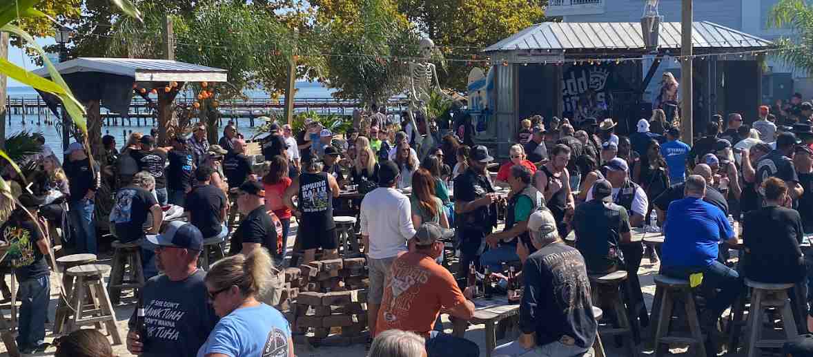 A live southern rock band performing on an outdoor stage at a bike fest, with a crowd of bikers enjoying the music - 11th Annual Colonial Beach Bike Fest A live southern rock band performing on an outdoor stage at a bike fest, with a crowd of bikers enjoying the music - 11th Annual Colonial Beach Bike Fest