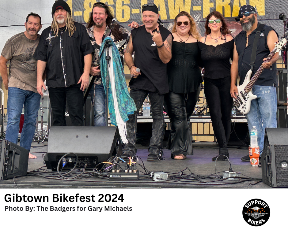 Live rock band performing on an outdoor stage to a crowd of bikers with Biker Hypnotist Gary Michaels - Gibtown Bike Fest