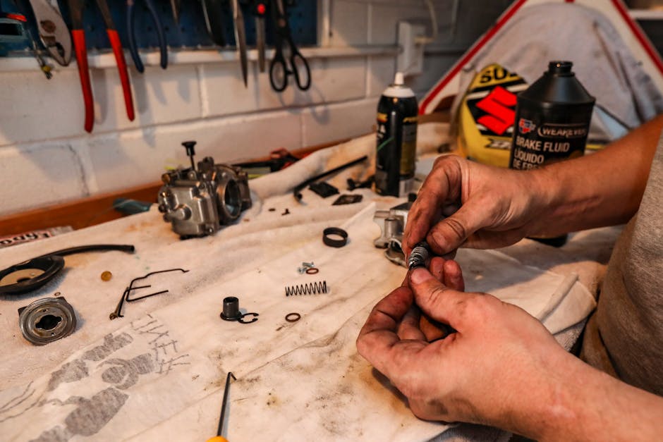Motorcycle parts and accessories laid out on a workbench - Motorcycle repair shops