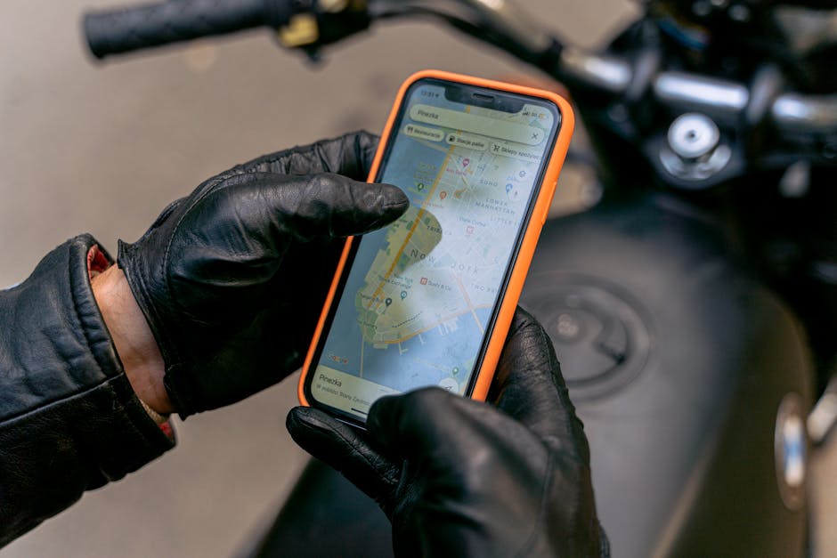A biker checking a map on their phone mounted to the handlebars - Best motorcycle routes Florida