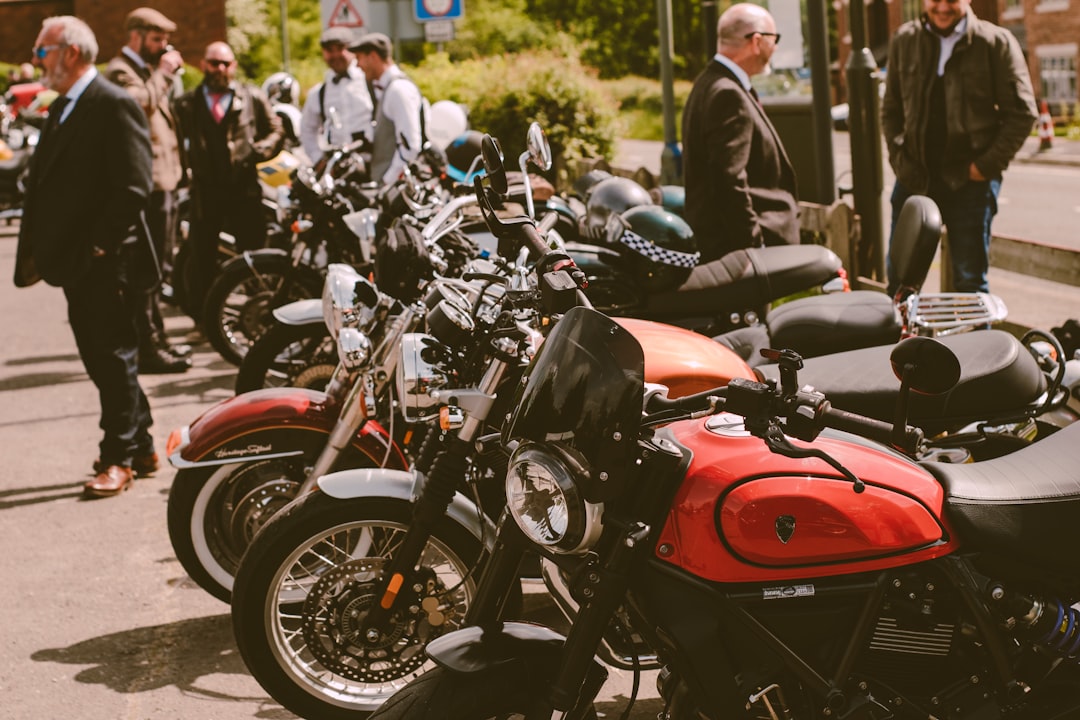 Row of American-style cruiser motorcycles parked along a scenic highway - Motorcycle insurance quotes