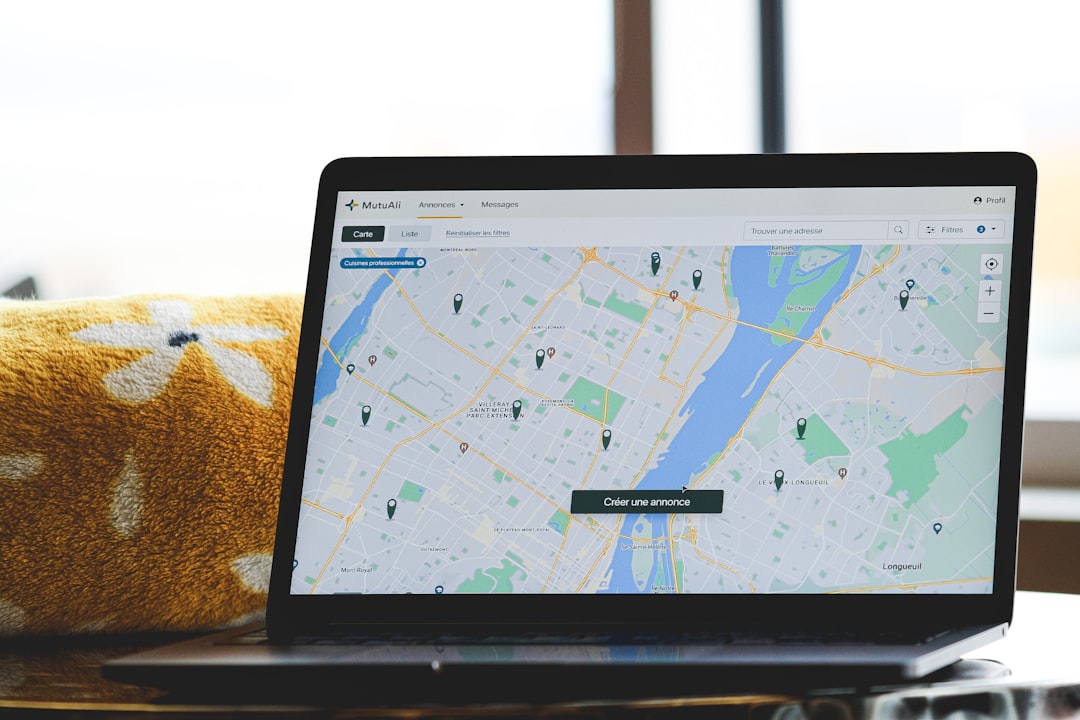 Rider planning charity ride route on laptop with maps and paperwork spread out - motorcycle ride for charity