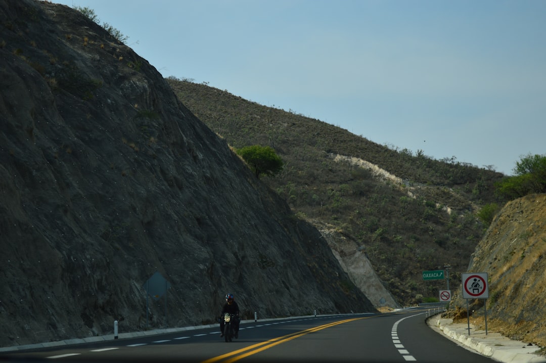 A winding road through the Black Hills, like Iron Mountain Road, with a motorcycle riding on it - What happened at sturgis rally 2025