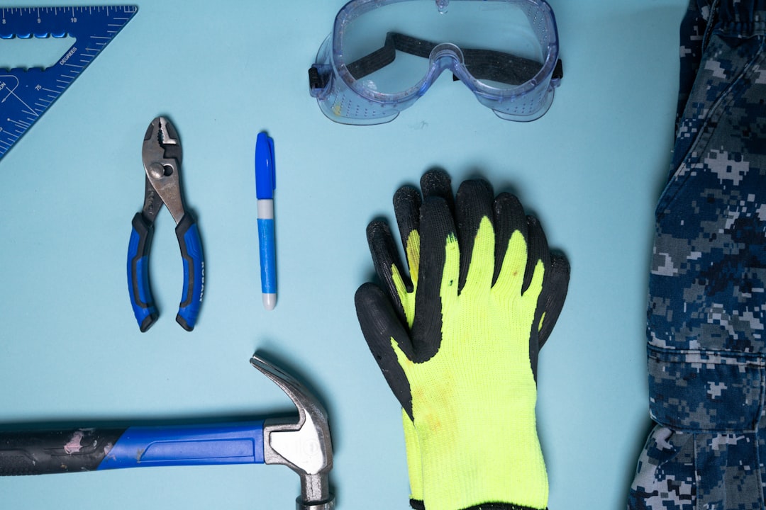 necessary tools and safety gear laid out neatly on a workbench, including safety glasses, gloves, a socket set, and a wire brush - disconnect motorcycle battery necessary tools and safety gear laid out neatly on a workbench, including safety glasses, gloves, a socket set, and a wire brush - disconnect motorcycle battery
